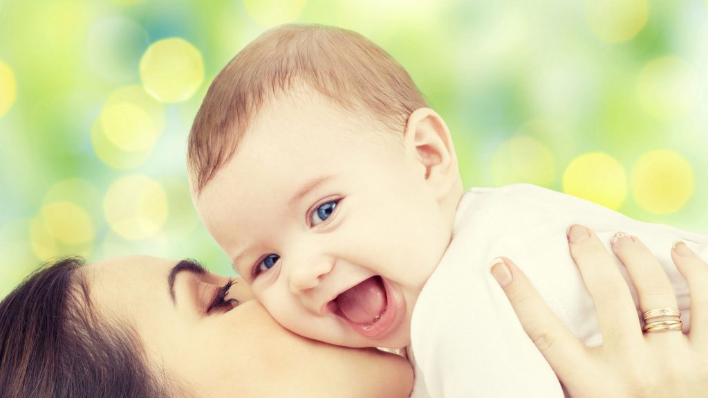 Lachendes Baby mit Mutter